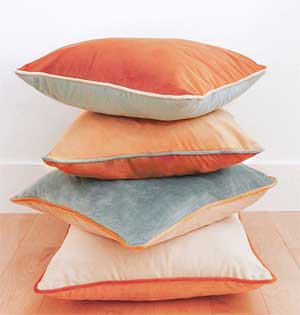 Stack of 4 Velvet Pillows in Neutral Colors with Contrasting Piping on Edges